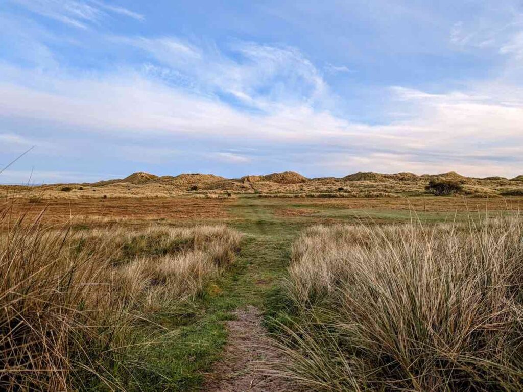 Open area leading to sandy dunes at the Holy Island of Lindisfarne, Northumberland