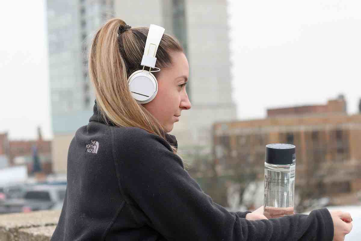 Running without music - picture of a female runner with headphones on