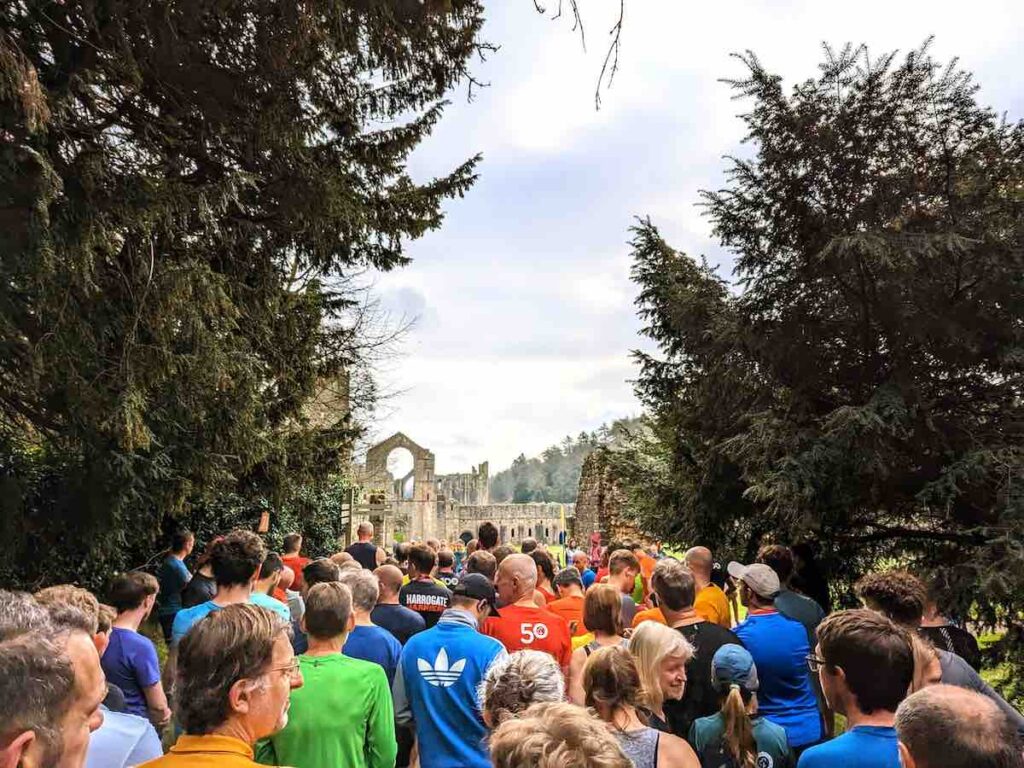 Fountains Abbey parkrun - runners waiting at the start line overlooking the abbey ruins