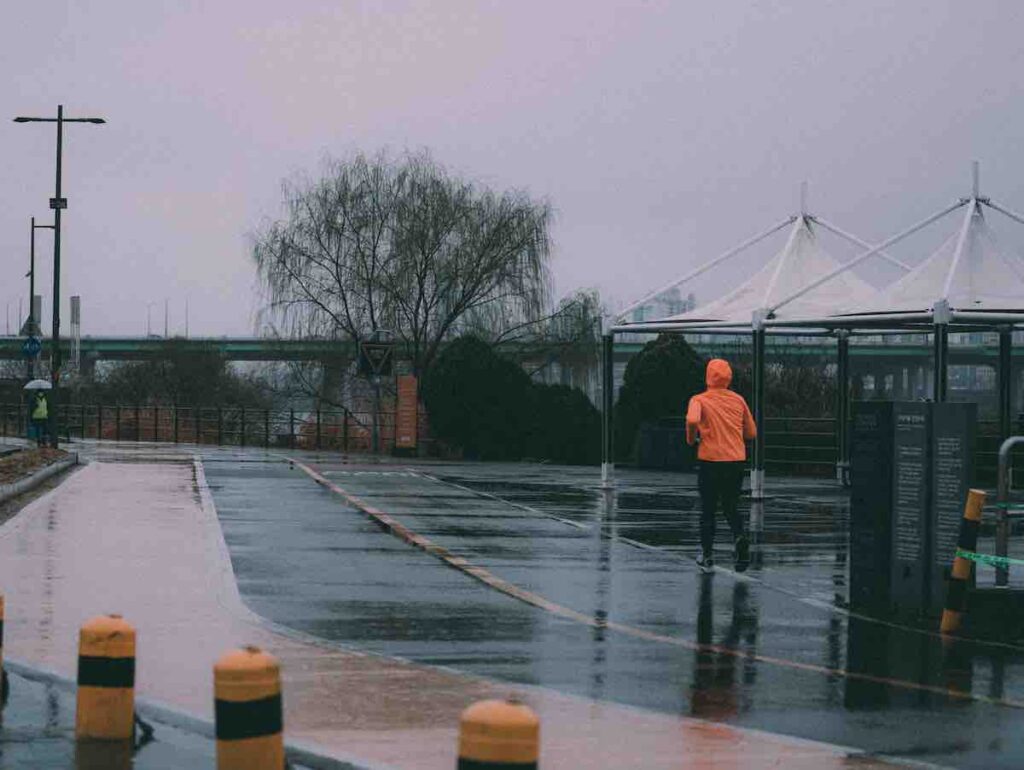 Lone runner in the rain on an empty street