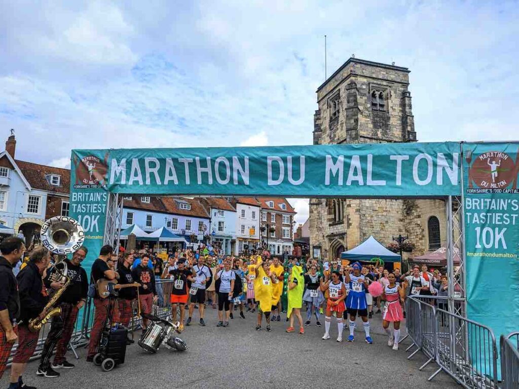 Start line of the Marathon Du Malton food Le Classique with runners in fancy dress