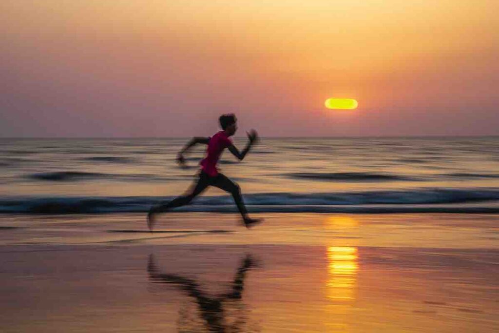 Running on the beach at sunset