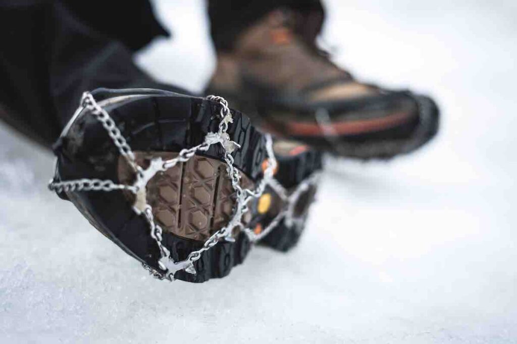 Pair of running shoe cleats on a bed of snow